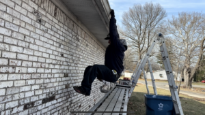 Hanging on gutter showing strength